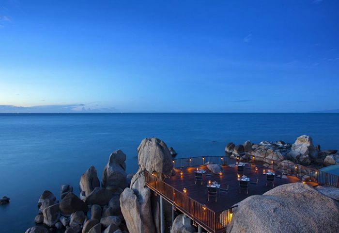 Silavadee Pool Spa Resort gay-friendly hotel dining deck on rocks overlooking the ocean. Romantic setting for gay travelers.