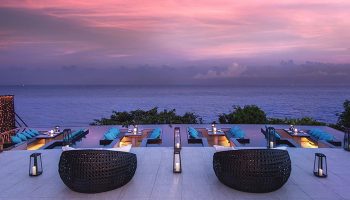 Silavadee Pool Spa Resort gay-friendly hotel view. Outdoor dining with ocean sunset. Luxury travel for gay men. Romantic resort.