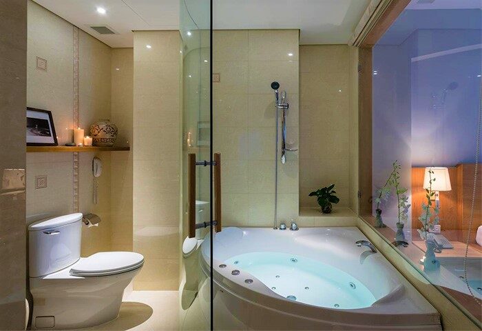 Bathroom at Silverland Yen Hotel, a gay-friendly hotel. Features a jacuzzi tub, toilet, and shower. Ideal for gay travelers.