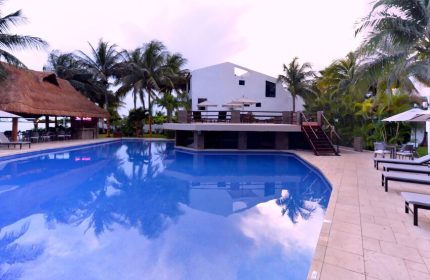 Sina Suites gay-friendly hotel pool view. Relax at this tropical resort with a bar, lounge chairs, and a refreshing pool. Perfect for gay men travel.