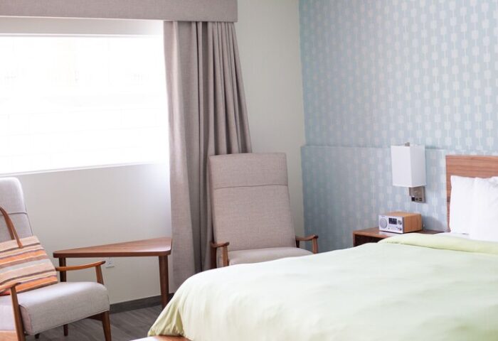 Skylark Hotel's gay-friendly room: bed, chairs, and stylish decor. A welcoming space for gay travelers seeking comfort and relaxation.
