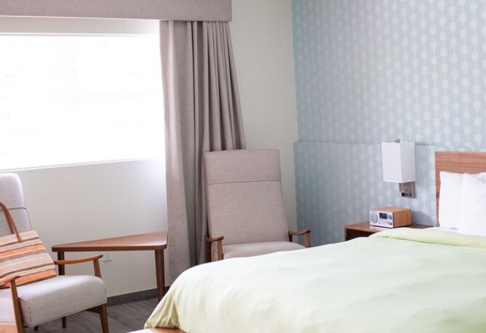 Skylark Hotel's gay-friendly room: bed, chairs, and stylish decor. A welcoming space for gay travelers seeking comfort and relaxation.