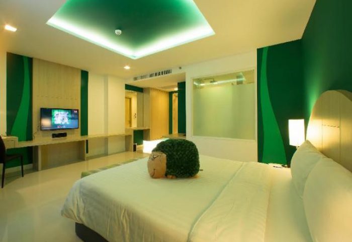 Sleep with Me Hotel Design Hotel at Patong room. Modern green decor, plush bed, & TV. Gay-friendly hotel for gay men travelers.