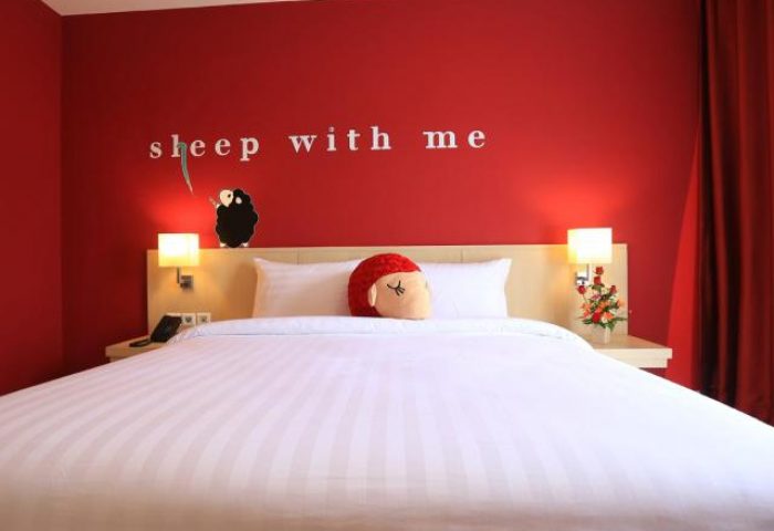 Sleep with Me Hotel Design Hotel at Patong room. Gay-friendly hotel with red decor, bed, and sheep with me text. Thailand travel.