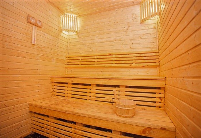 Sauna at Sleep with Me Hotel Design Hotel at Patong. Gay-friendly hotel with wooden benches, bucket, and thermometer. Sauna for relaxation.