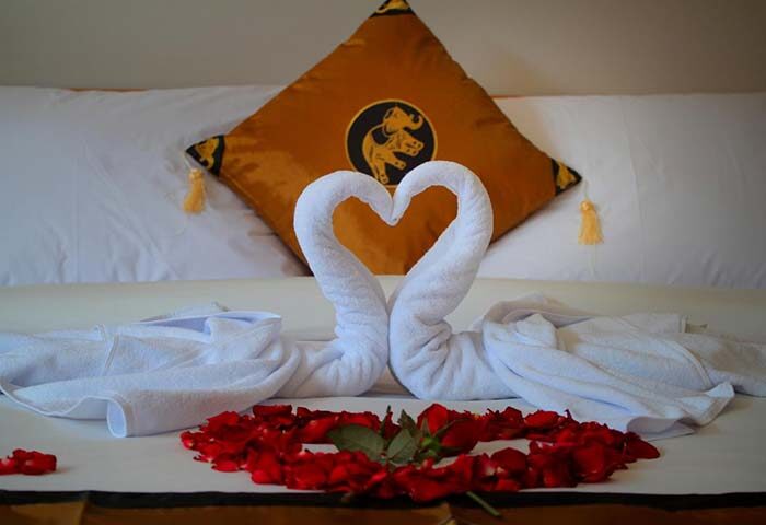 Sleepwell Seminyak gay-friendly hotel room with swan towels, rose petals, and an elephant pillow. A romantic welcome for gay travelers.
