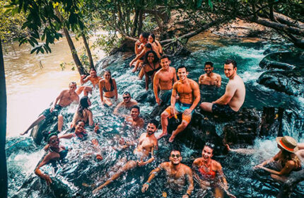Gay-friendly hotel: Slumber party at The Beach Hostel. Group of people enjoying a river at a gay-friendly hostel. Gay travel advice.