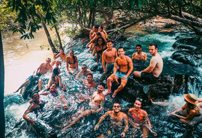 Gay-friendly hotel: Slumber party at The Beach Hostel. Group of people enjoying a river at a gay-friendly hostel. Gay travel advice.