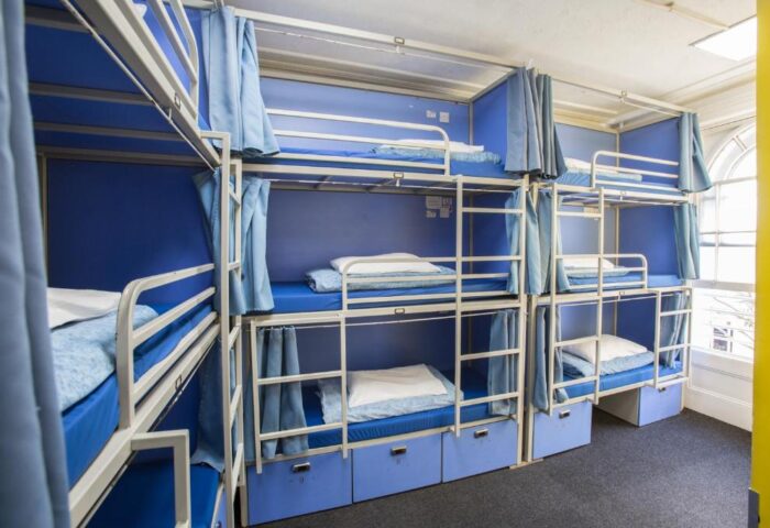 Smart Hyde Park Inn Hostel's dorm. Blue bunk beds with curtains for privacy. Gay-friendly hotel for budget travelers.
