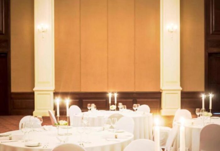 Sofitel Angkor Phokeethra Golf & Spa Resort's banquet hall. Tables set for a wedding, candles lit, creating a romantic atmosphere. Gay-friendly hotel.