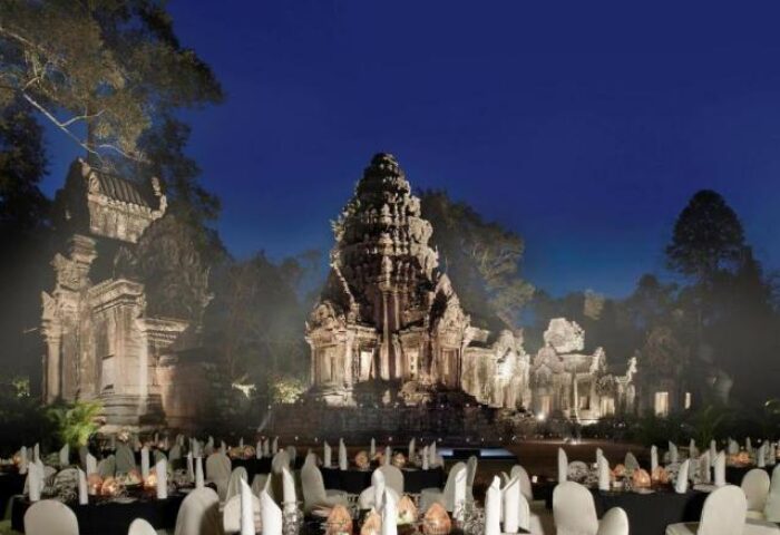 Sofitel Angkor Phokeethra Golf & Spa Resort: Gay-friendly hotel event with temple backdrop. Tables set for dinner at night in Siem Reap, Cambodia.