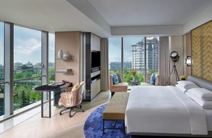 Gay-friendly Sofitel Beijing Central hotel room. Modern design, city view, desk, bed, and seating area. Upscale accommodations in Beijing.