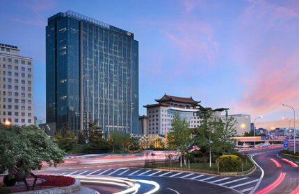 Sofitel Beijing Central, a gay-friendly hotel. Modern architecture, city view at dusk. Ideal for gay men's travel in Beijing, China.