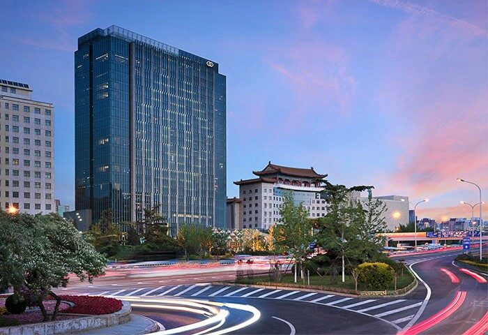 Sofitel Beijing Central, a gay-friendly hotel. Modern architecture, city view at dusk. Ideal for gay men's travel in Beijing, China.
