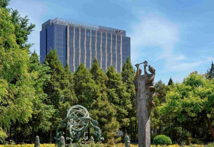Gay-Friendly Sofitel Beijing Central hotel view. Sculpture garden with modern building. Popular choice for gay men travelers in Beijing.