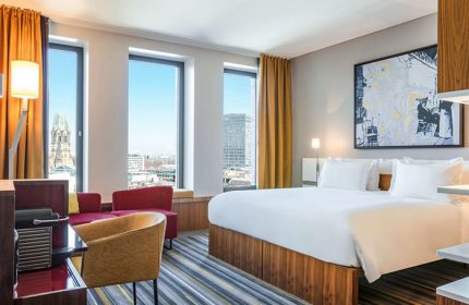 Dorint Kurfurstendamm Hotel room. Gay-friendly, pet-friendly Sofitel Berlin Kurfurstendamm Hotel. City view, bed, seating area.