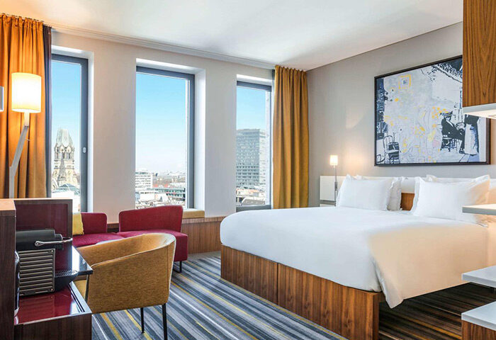 Dorint Kurfurstendamm Hotel room. Gay-friendly, pet-friendly Sofitel Berlin Kurfurstendamm Hotel. City view, bed, seating area.