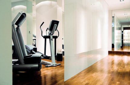 Dorint Kurfurstendamm Hotel gym. Treadmill and elliptical machine in a bright, modern fitness center. Gay-friendly hotel in Berlin.