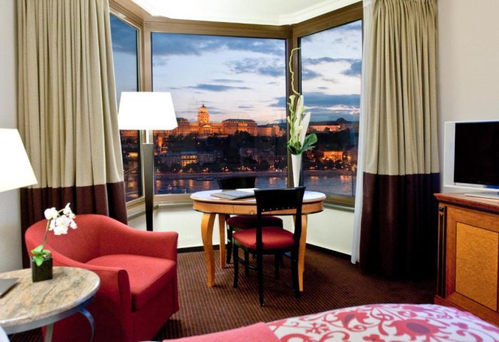Sofitel Budapest Hotel room with a view. Pet-friendly, gay-friendly hotel room overlooks the Danube River and cityscape at dusk.