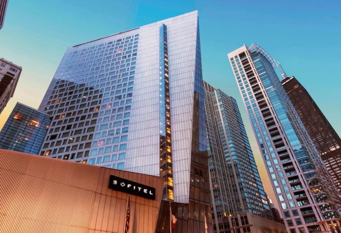 Sofitel Chicago Magnificent Mile, a gay-friendly hotel. View of the hotel's exterior with other skyscrapers in the background.