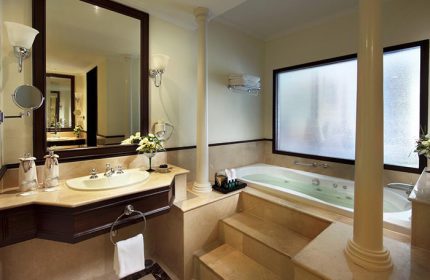 Bathroom at Sofitel Krabi Phokeethra Golf and Spa Resort, a gay-friendly hotel. Features a jacuzzi tub, sink, and large mirror. Luxury travel.