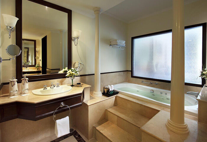 Bathroom at Sofitel Krabi Phokeethra Golf and Spa Resort, a gay-friendly hotel. Features a jacuzzi tub, sink, and large mirror. Luxury travel.