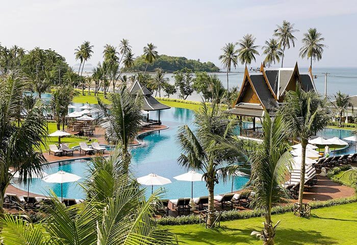 Sofitel Krabi Phokeethra Golf and Spa Resort's pool. Gay-friendly hotel with palm trees, Thai pavilions, sunbeds and ocean view.