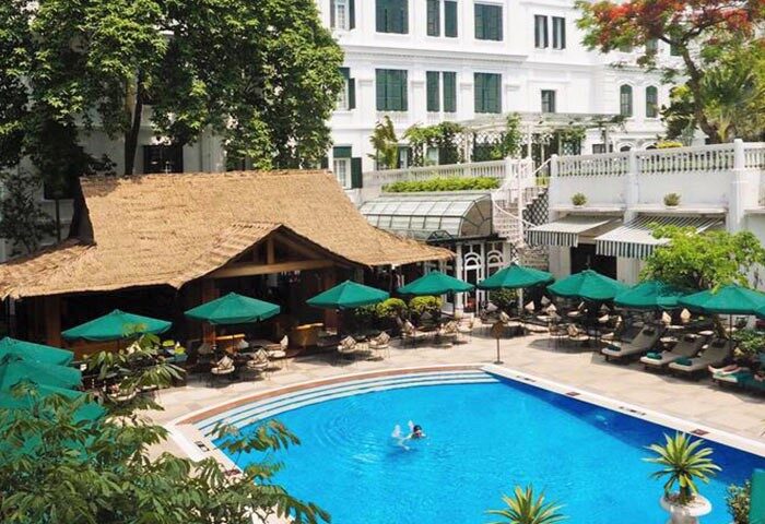 Pool view at Sofitel Legend Metropole Hanoi Hotel, a gay-friendly hotel. Relaxing by the pool, a perfect gay travel destination in Hanoi.