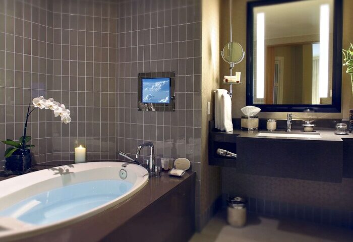 Sofitel Los Angeles at Beverly Hills Hotel bathroom. Gay-friendly hotel with tub, TV, and modern design. Upscale travel for gay men.