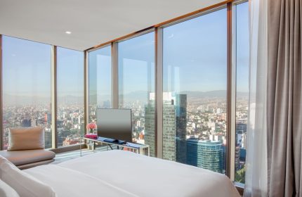 Gay-friendly Sofitel Mexico City Reforma hotel room. Panoramic city view from bedroom. Luxury travel for gay men in Mexico City.