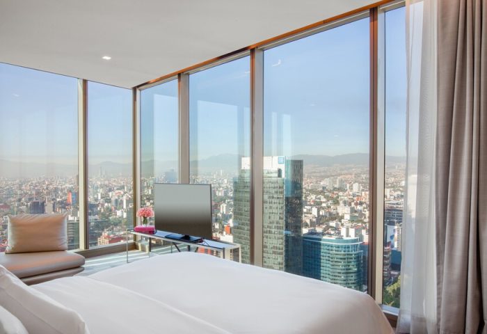 Gay-friendly Sofitel Mexico City Reforma hotel room. Panoramic city view from bedroom. Luxury travel for gay men in Mexico City.