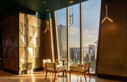 Sofitel Mexico City Reforma gay-friendly hotel lounge area. Armchairs and a table with city views. Modern design, perfect for gay travelers.