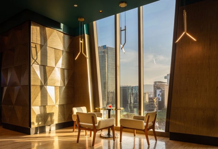 Sofitel Mexico City Reforma gay-friendly hotel lounge area. Armchairs and a table with city views. Modern design, perfect for gay travelers.
