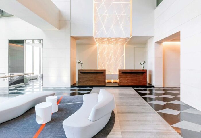 Sofitel Mexico City Reforma's lobby. A gay-friendly hotel with modern design, reception desks, stylish seating and geometric lighting.