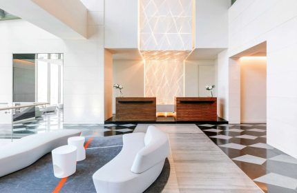 Sofitel Mexico City Reforma's lobby. A gay-friendly hotel with modern design, reception desks, stylish seating and geometric lighting.