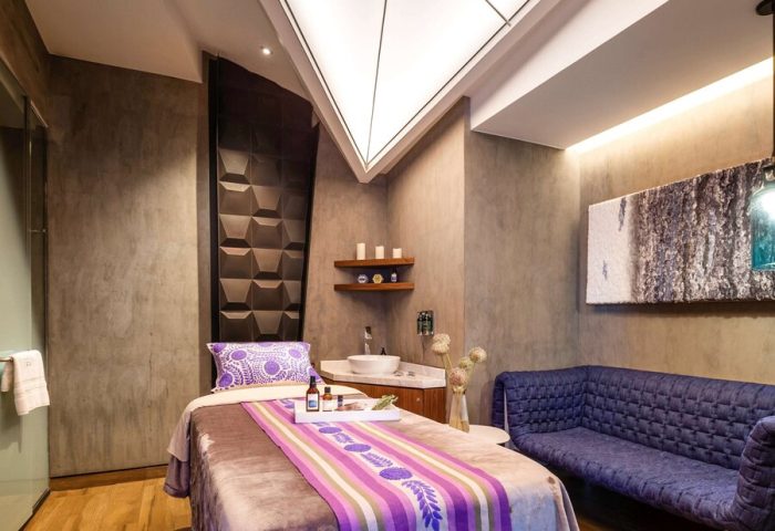Spa room at the gay-friendly Sofitel Mexico City Reforma hotel. Massage table, purple accents, and modern design for relaxing gay travel.