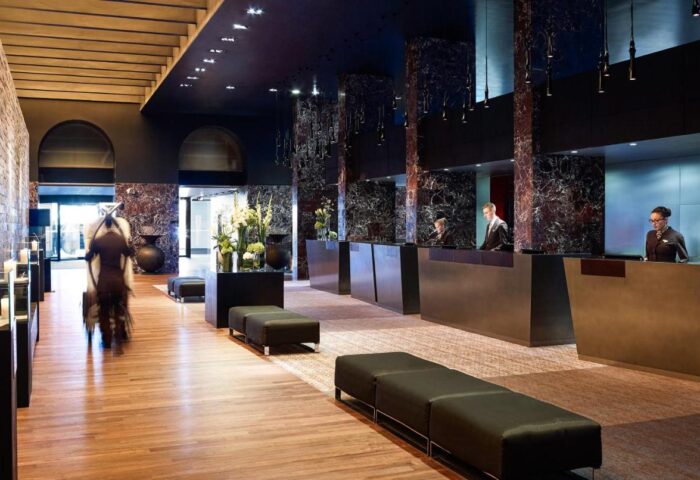 Sofitel Munich Bayerpost Hotel lobby. Gay-friendly hotel with modern design, reception area, and stylish decor. Luxury travel for gay men in Munich.