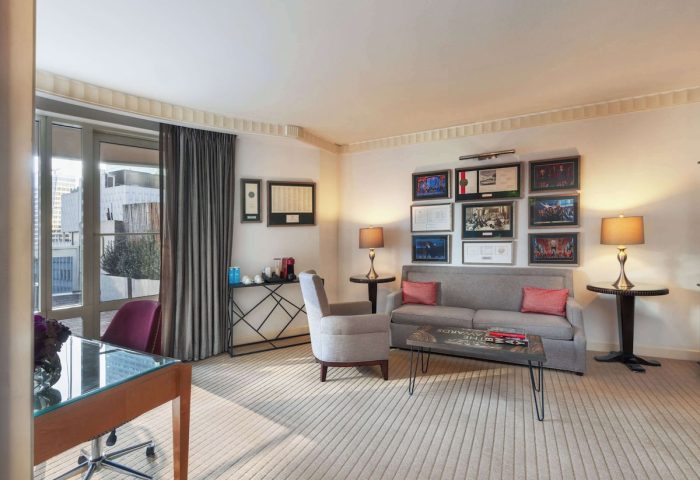 Sofitel New York's gay-friendly hotel room. The suite features a desk, sofa, and balcony, offering a luxurious stay in NYC for gay travelers.