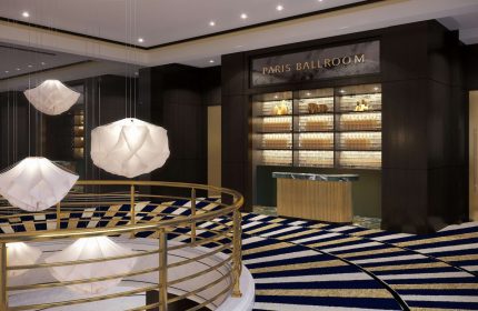 Sofitel New York's Paris Ballroom entrance. Gay-friendly hotel with modern design, unique lighting, and stylish decor. Luxury travel for gay men.