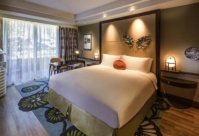 Sofitel Singapore Sentosa Resort & Spa room. Gay-friendly hotel with SG Clean Certified. Luxurious bedding, desk, & stylish decor.