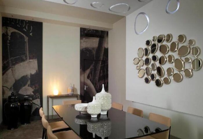 Sofitel St James London Hotel dining area. Pet-friendly, gay-friendly hotel. Modern decor, black table, artistic wall mirrors.