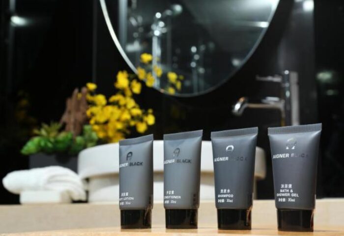 Sohotel's gay-friendly amenities: Aigner Black toiletries (lotion, conditioner, shampoo, shower gel) on a bathroom counter. Upscale hotel experience.