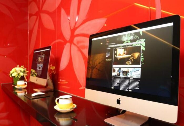 Sohotel's stylish lobby with iMacs. Gay-friendly hotel featuring modern decor, computers, and a welcoming atmosphere. Ideal for gay travelers.