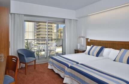 Sol Costablanca Adults-only Hotel room. Gay-friendly hotel room with balcony view in Benidorm, Costa Blanca, Spain. Twin beds with blue accents.