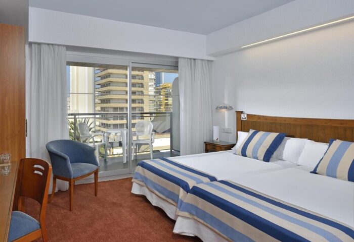 Sol Costablanca Adults-only Hotel room. Gay-friendly hotel room with balcony view in Benidorm, Costa Blanca, Spain. Twin beds with blue accents.