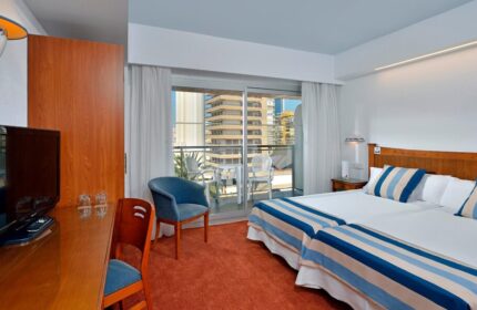 Sol Costablanca Adults Only hotel room. Gay-friendly hotel featuring twin beds, balcony, desk, and city view. Perfect for gay travel.
