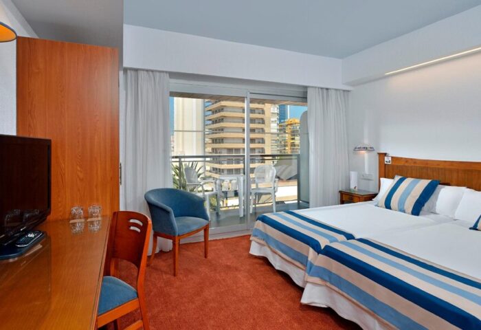 Sol Costablanca Adults Only hotel room. Gay-friendly hotel featuring twin beds, balcony, desk, and city view. Perfect for gay travel.