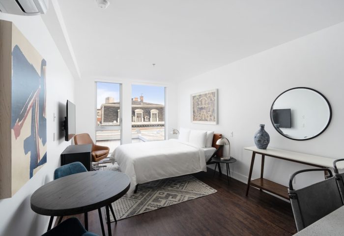 Sonder Gare Saint Denis gay-friendly hotel room. Modern interior with bed, table, and art. A comfortable stay for gay travelers.