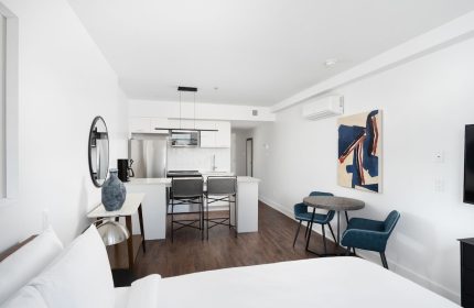 Sonder Gare Saint Denis gay-friendly hotel room. Modern interior with kitchen, table, chairs, and bed. Great for gay travel in Paris.