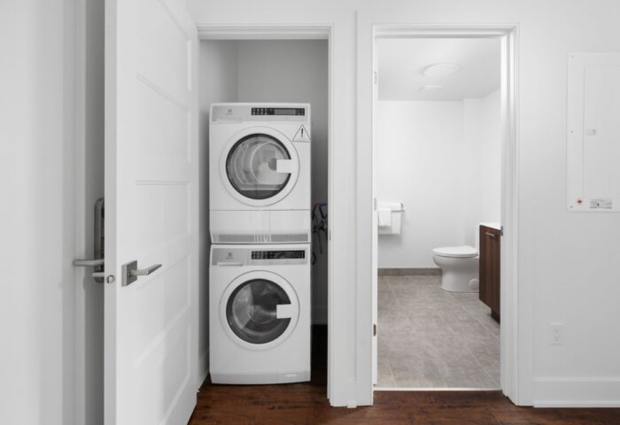Sonder Gare Saint Denis: Washer and dryer in a closet. Bathroom visible through doorway. Gay-friendly hotel with modern amenities.
